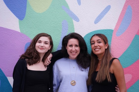 Photo of Blue Fever and Trill founders in front of a colorful mural