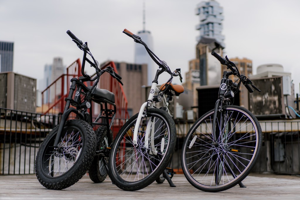three new Swft e-bikes in front of nyc skyline