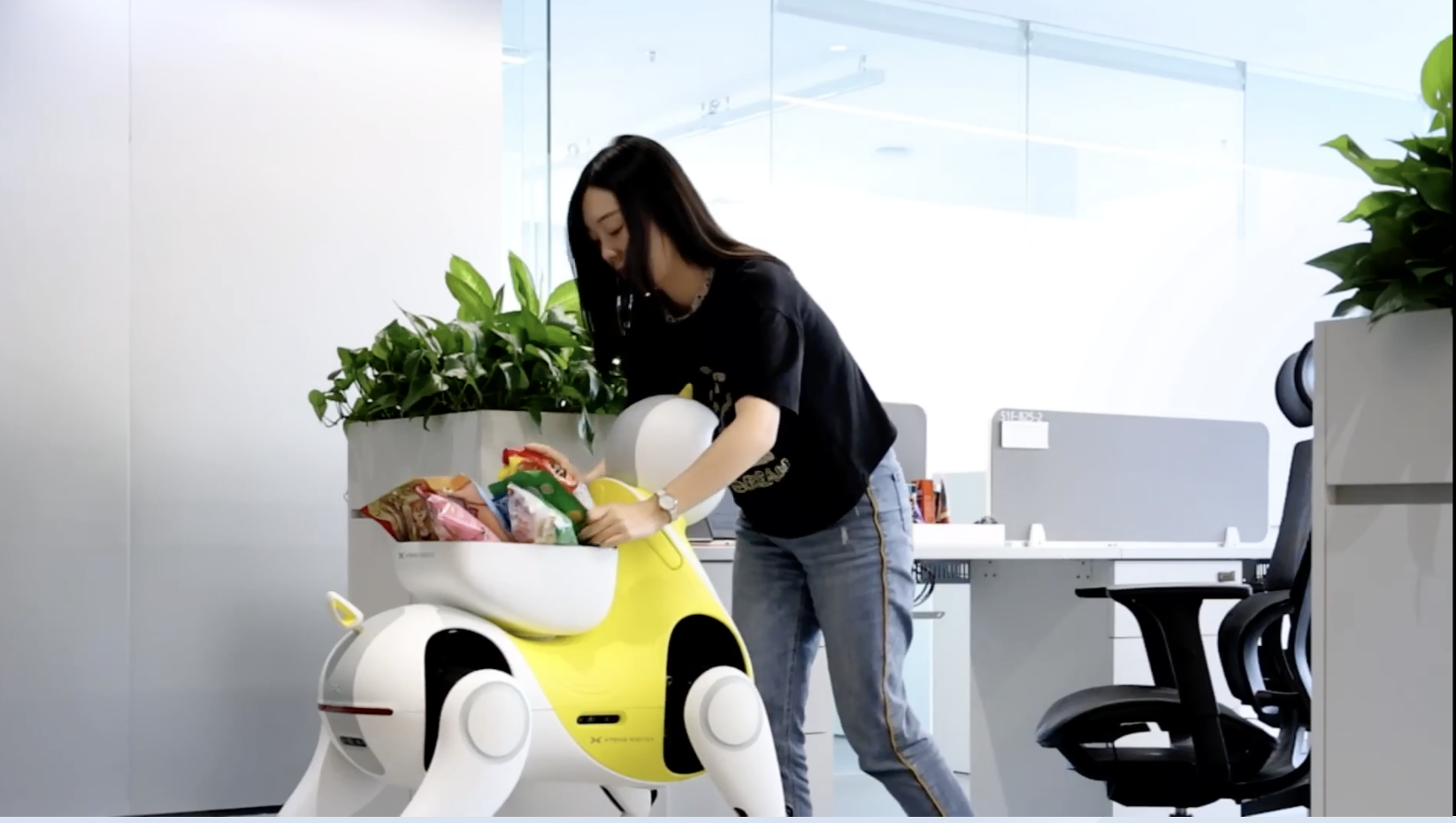 Woman in office loads Xpeng robotic pony with treats to be delivered