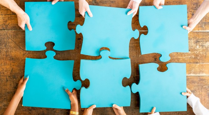 Team of doctors and nurses and business people work together to make the pieces fit.