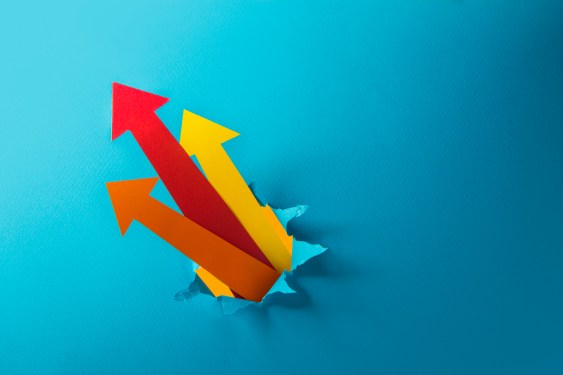 A group of arrow head moving upwards, breaking through coloured background.