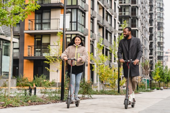Image of two people riding electric scooters.