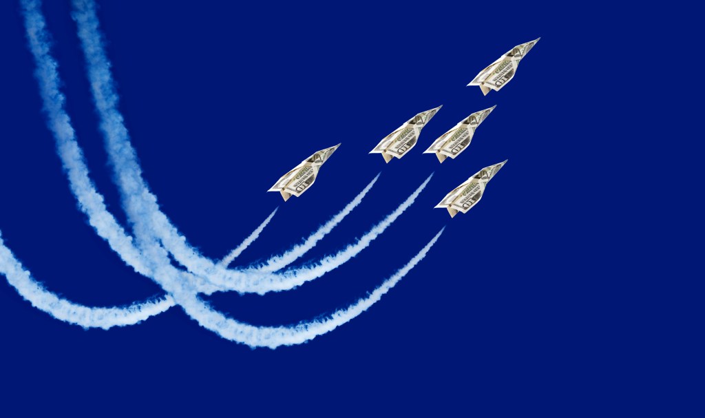 Five paper planes flying through the sky