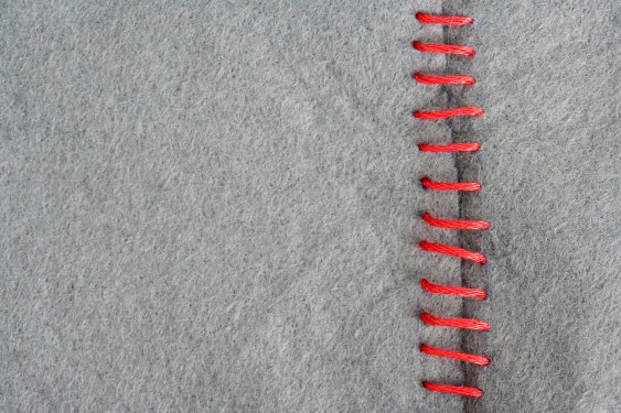 Red stitching on gray fabric
