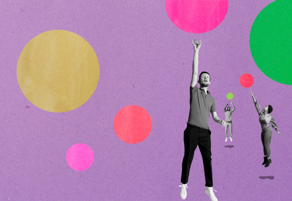 three people jumping for bubbles