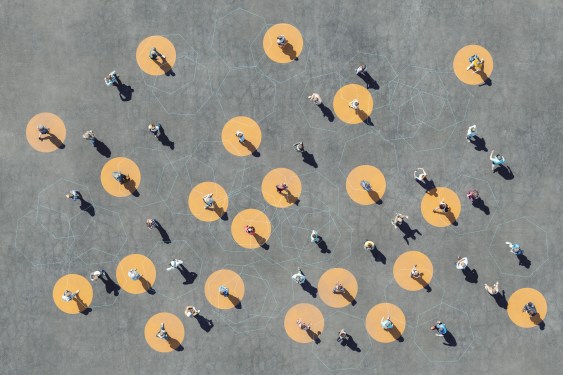 Image of people standing on a gray surface amid yellow dots.