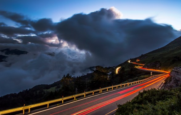 High angle view of light trails on road against sky at night