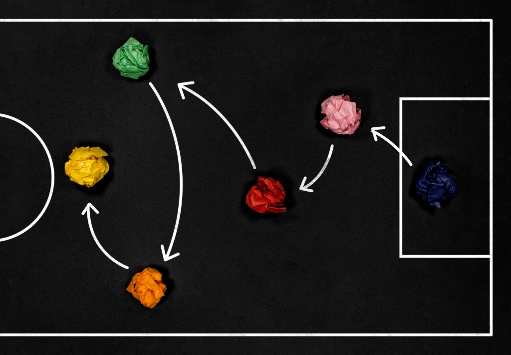 Football play strategy drawn out on a chalk board