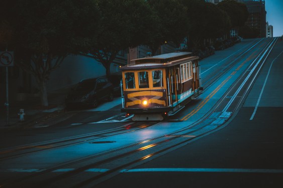 Magical twilight view of historic Cable Car riding on famous California Street at dawn before sunrise, San Francisco, California, USA (Magical twilight view of historic Cable Car riding on famous California Street at dawn before sunrise, San Francisco