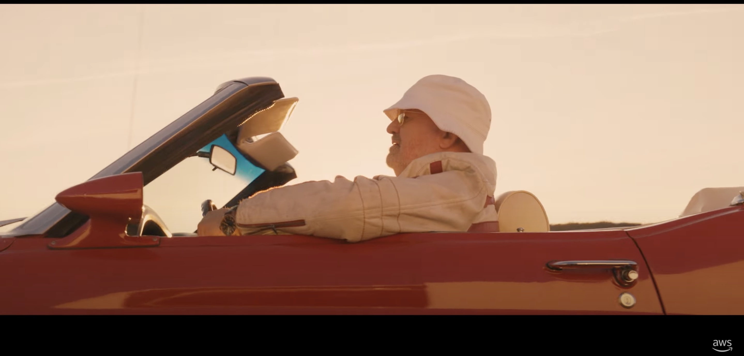 Amazon CTO Werner Vogels driving a classic Mustang in a promo film for re:Invent 2021