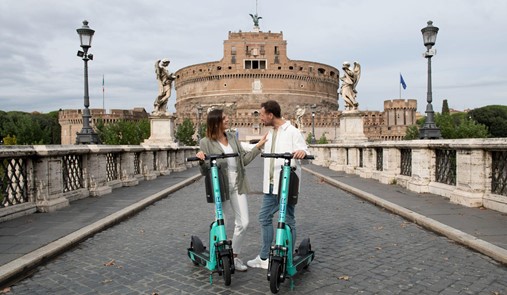 man and woman on tier mobility escooters in italy