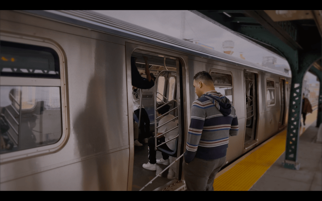 visually impaired man using Moovit directions and wewalk smart cane gets on nyc subway