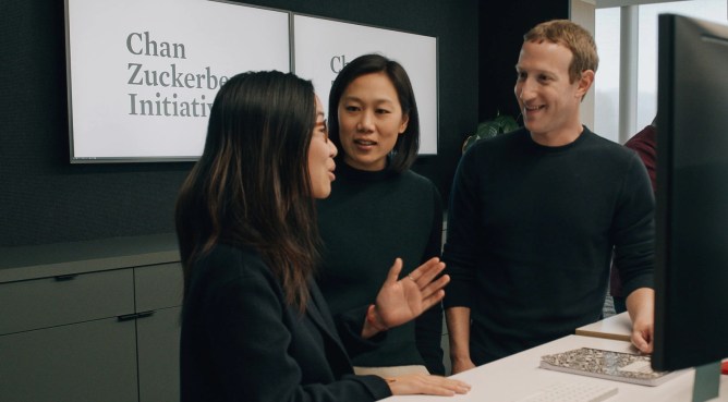 Priscilla Chan and Mark Zuckerberg talk to a CZI employee.