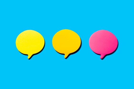 Yellow, Orange And Fuchsia Blank Notes In The Shape Of Comic Bubbles. Blue Background.