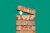 Egg between bricks on green background