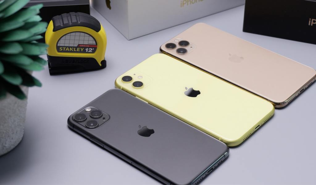 3 smartphones face down on a desk