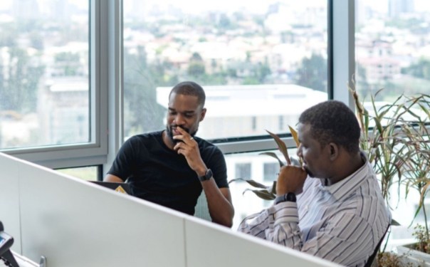 two men sitting in an office