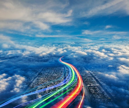 Streaming communications in the form of light trails streak over the city of los Angeles below.