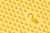 High angle view of many yellow padlocks on yellow background. One of them is open.