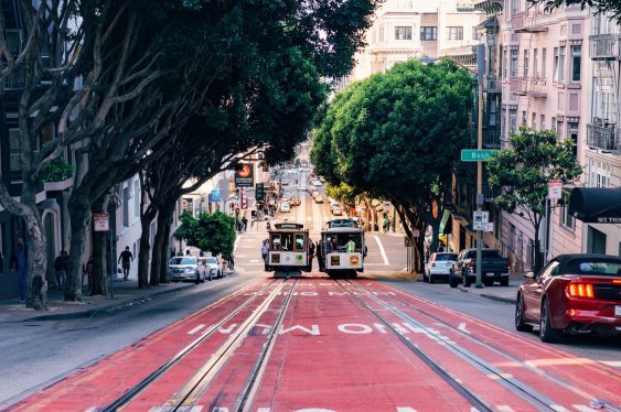 Two cable cars are passing each other at the intersection of Powell and Bush streets in San Francisco, CA
