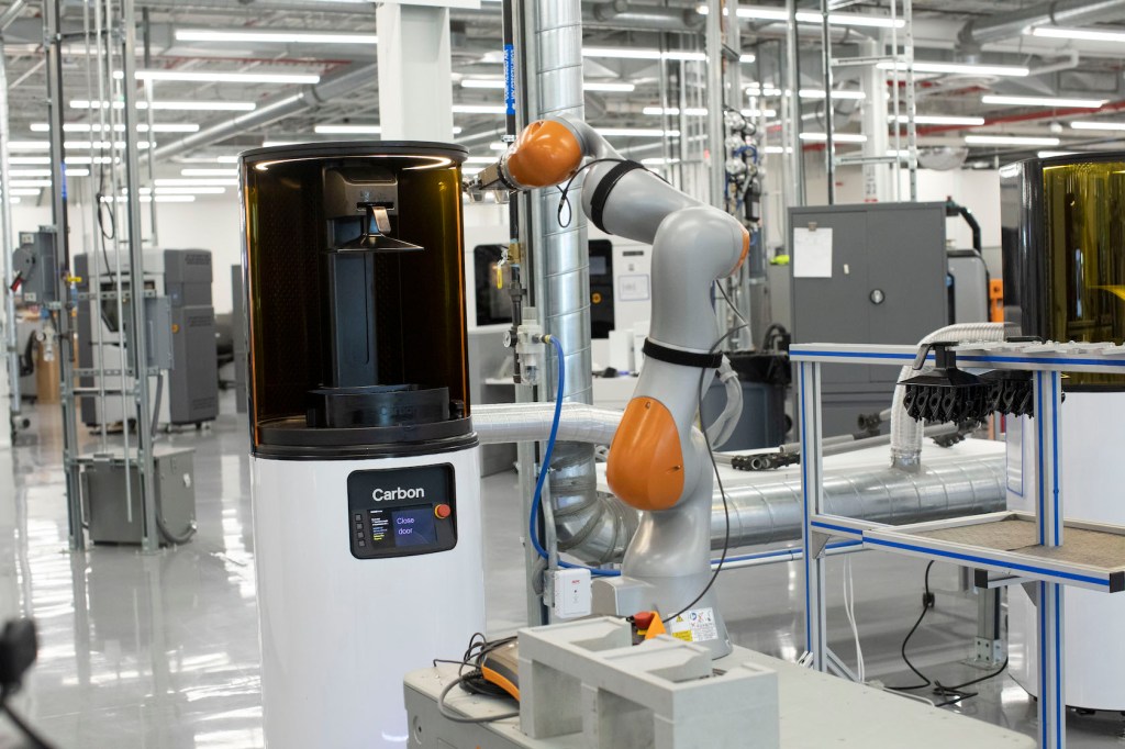 A Ford KUKA robot operating a Carbon 3D printer