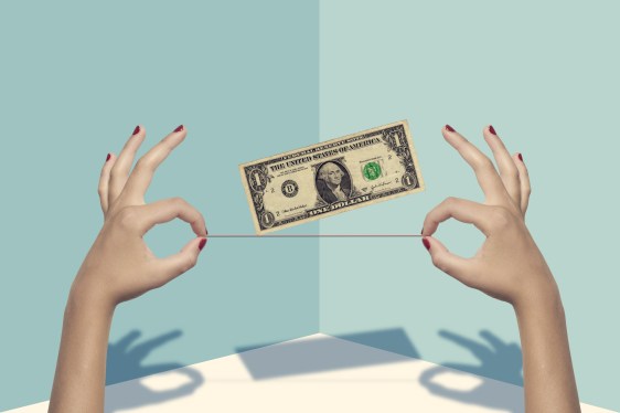 Image of a woman's hands holding a red thread with a dollar hovering above it.