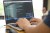 programmer or developer working at home and typing source code with laptop