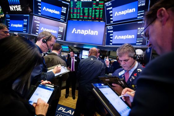 Traders work beneath monitors displaying Anaplan Inc. signage during the company's initial public offering (IPO) on the floor of the New York Stock Exchange (NYSE) in New York, U.S., on Friday, Oct. 12, 2018. U.S. stocks surged Friday after two days of market tumult as trade tensions with China seemed to ease, at least temporarily, with the countries planning to meet in November and the Treasury Department saying that China isn't manipulating its currency. Photographer: Michael Nagle/Bloomberg via Getty Images