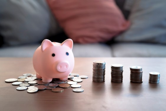 Stack of coins and piggy bank, Saving money concept.