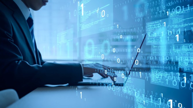 Man typing at keyboard with zeros and ones overlaid on the image.