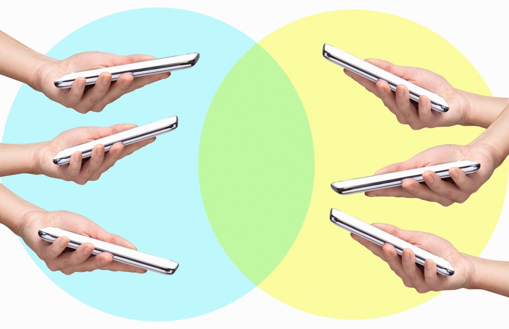 3 hands with smart phones in yellow bubble opposite 3 other smart phones in hands in blue bubbles creating green intersection, white background