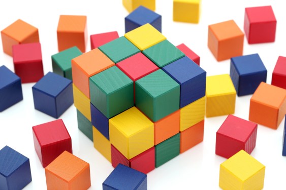 small wooden colorful square blocks puzzle on a white background