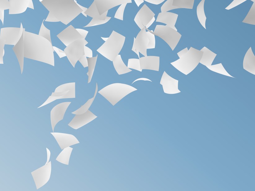 white papers flying on sky