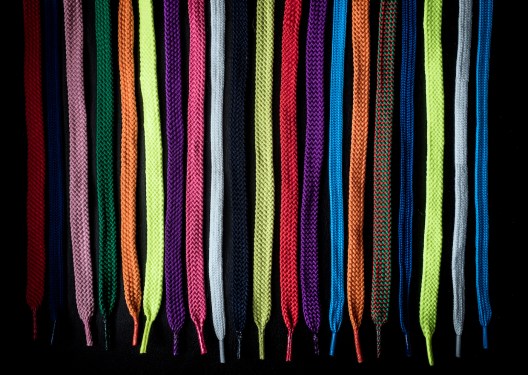 Close-Up Of Multi Colored Shoelaces Against Black Background