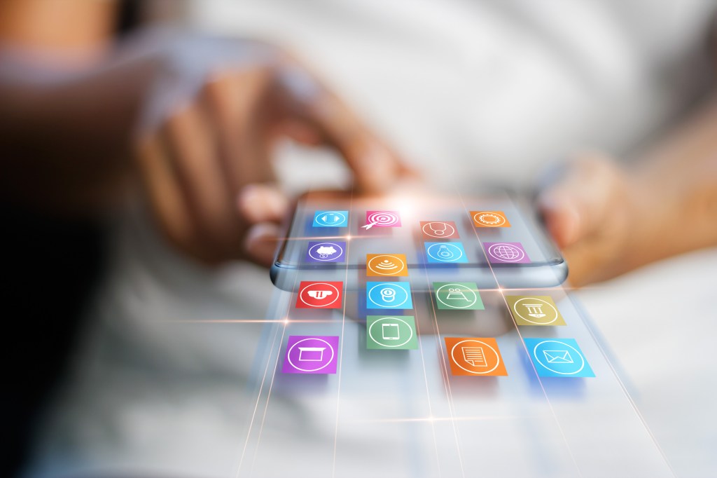 Mobile app icons coming out of mobile phone.