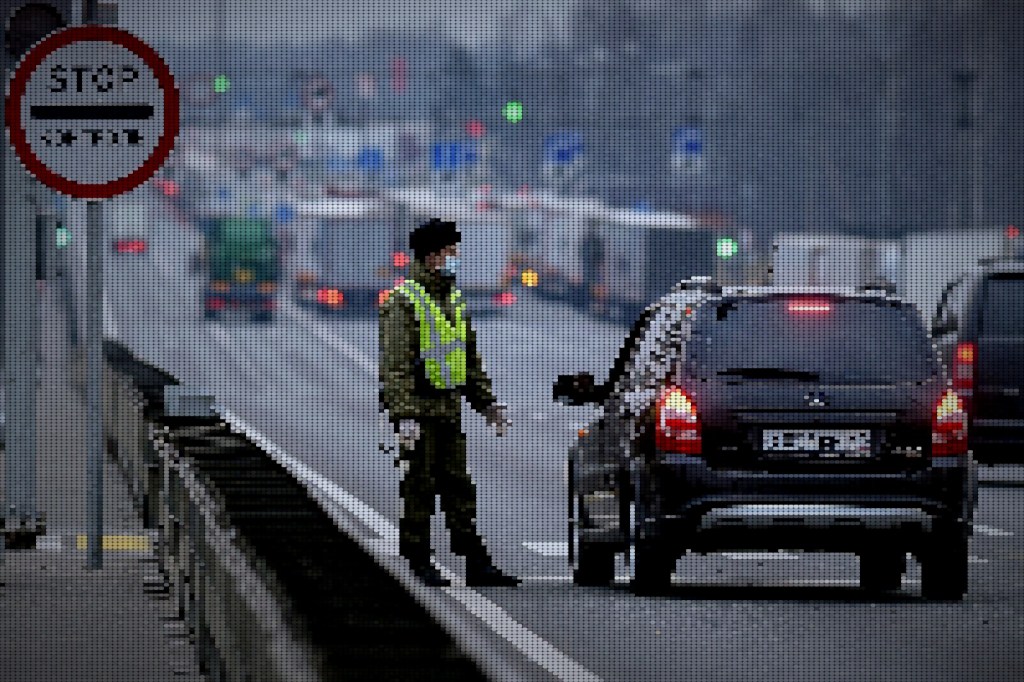 A Russian border guard checks documents at the Russian-Belarus border checkpoint in the west of Russia.