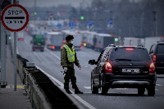 A Russian border guard checks documents at the Russian-Belarus border checkpoint in the west of Russia.