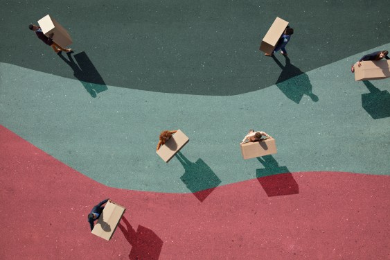 Image of a group of young adults, photographed from above, on various painted tarmac surface, at sunrise.