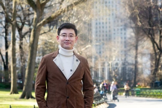 A picture of Ronghui Gu, founder and CEO of CertiK in front of trees