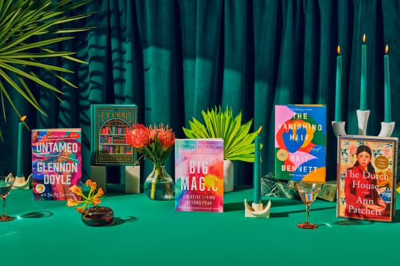 Books arranged on a decorative green background