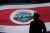 Silhouette of an honor guard in front of a flag of Costa Rica