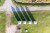 Four old beach huts photographed from straight above. The shadows seem to form four arrows pointing to the same directions.