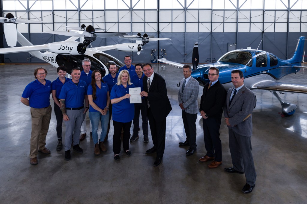 Joby Aviation crew in hangar in front of eVTOLs