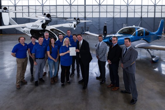 Joby Aviation crew in hangar in front of eVTOLs