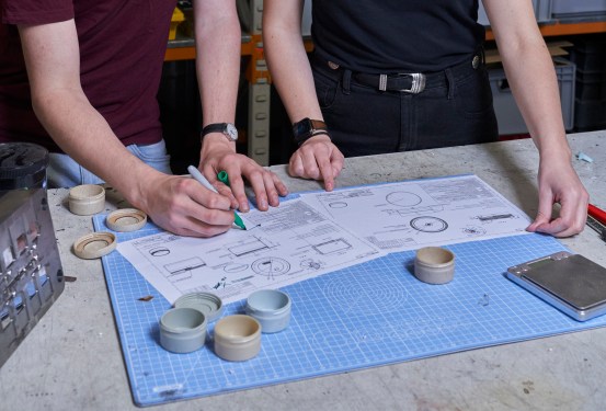 Shellworks engineers Callan George and David Cattermole review engineering drawings and prototype parts.