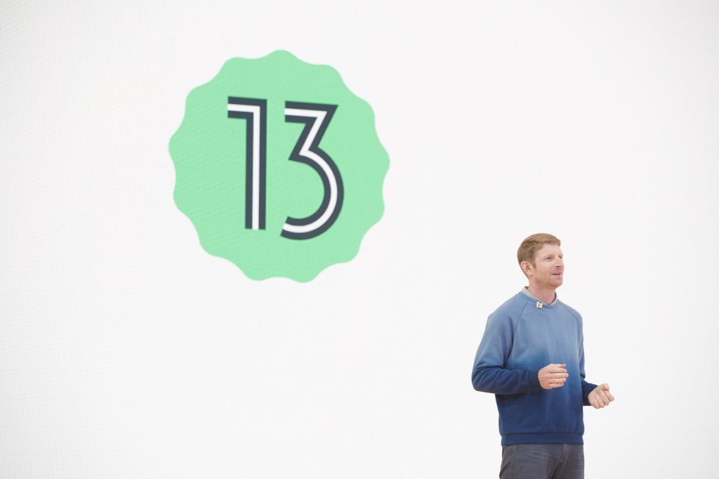 man standing in front of no. 13