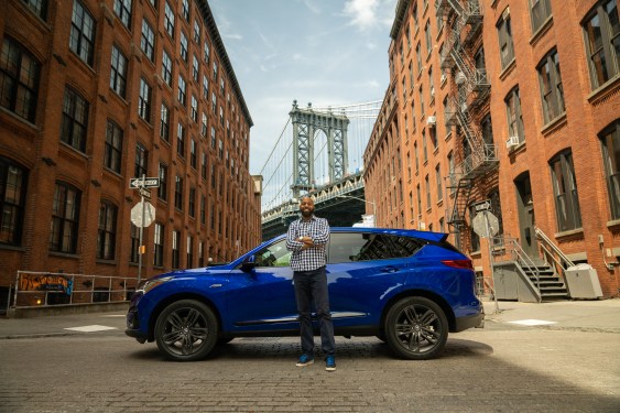 Prospective host for Turo in front of car in front of Brooklyn Bridge