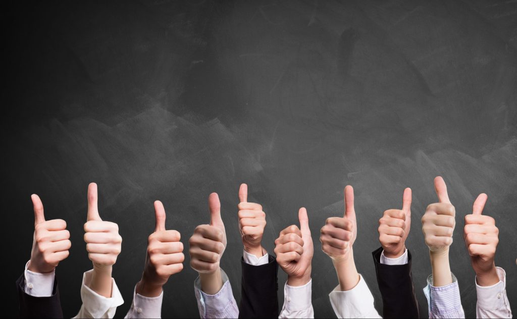 10 thumbs up in front of a blackboard; how to run board meetings