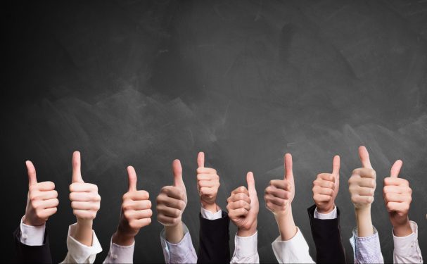 10 thumbs up in front of a blackboard; how to run board meetings