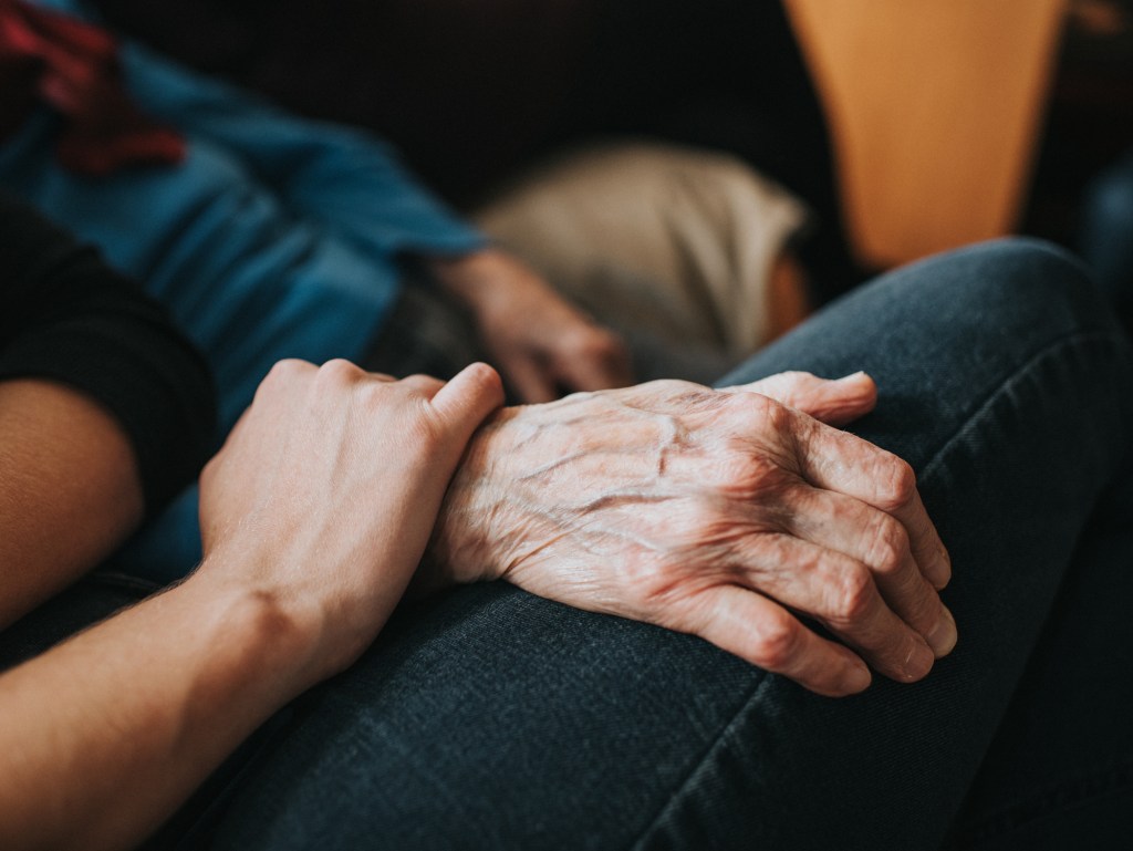 ounger person holder an older persons hand, used in a post about Aidaly